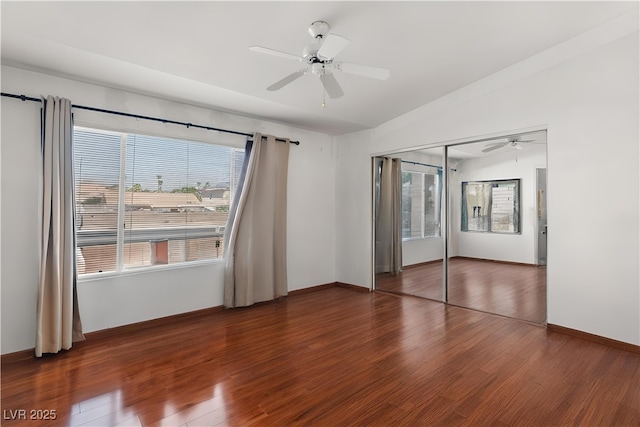 350 S Durango Dr Unit 202, Las Vegas, NV 89145 - unfurnished bedroom with multiple windows, wood finished floors, lofted ceiling, and a ceiling fan