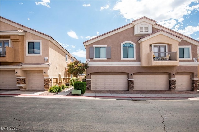 1155 Heavenly Harvest Pl Unit 3, Henderson, NV 89002 - mediterranean / spanish-style house with stone siding, stucco siding, and a balcony