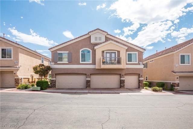 1155 Heavenly Harvest Pl Unit 3, Henderson, NV 89002 - mediterranean / spanish home with a balcony, stucco siding, an attached garage, and stone siding
