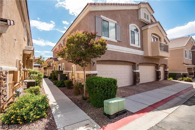 1155 Heavenly Harvest Pl Unit 3, Henderson, NV 89002 - view of front of house with stucco siding, an attached garage, driveway, and a residential view