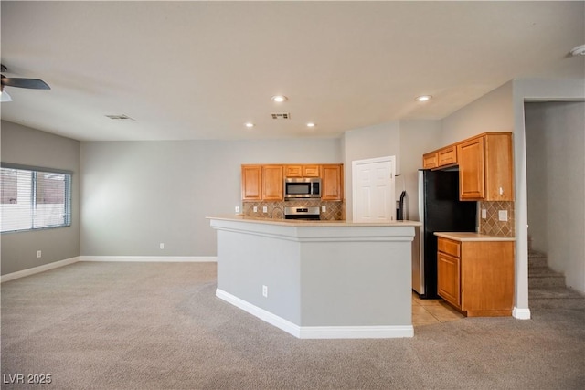 1155 Heavenly Harvest Pl Unit 3, Henderson, NV 89002 - kitchen with stainless steel appliances, light carpet, tasteful backsplash, light countertops, and recessed lighting