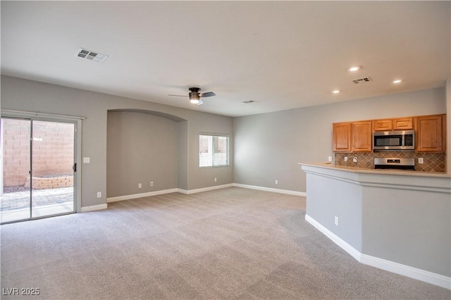 1155 Heavenly Harvest Pl Unit 3, Henderson, NV 89002 - kitchen featuring appliances with stainless steel finishes, ceiling fan, light colored carpet, backsplash, and recessed lighting
