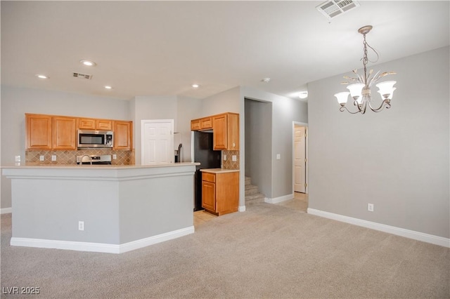 1155 Heavenly Harvest Pl Unit 3, Henderson, NV 89002 - kitchen with stainless steel appliances, light carpet, decorative backsplash, a chandelier, and recessed lighting