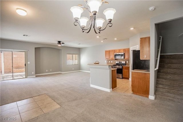 1155 Heavenly Harvest Pl Unit 3, Henderson, NV 89002 - kitchen featuring stainless steel appliances, light carpet, a chandelier, light tile patterned floors, and a ceiling fan