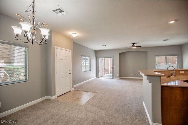 1155 Heavenly Harvest Pl Unit 3, Henderson, NV 89002 - kitchen with light colored carpet, a chandelier, decorative light fixtures, a ceiling fan, and open floor plan