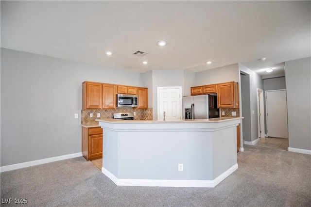 1155 Heavenly Harvest Pl Unit 3, Henderson, NV 89002 - kitchen featuring stainless steel appliances, light colored carpet, decorative backsplash, light countertops, and recessed lighting