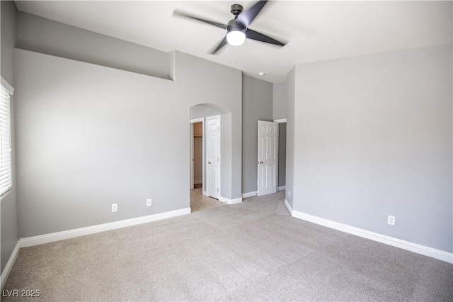 1155 Heavenly Harvest Pl Unit 3, Henderson, NV 89002 - unfurnished bedroom with light carpet, arched walkways, vaulted ceiling, and ceiling fan