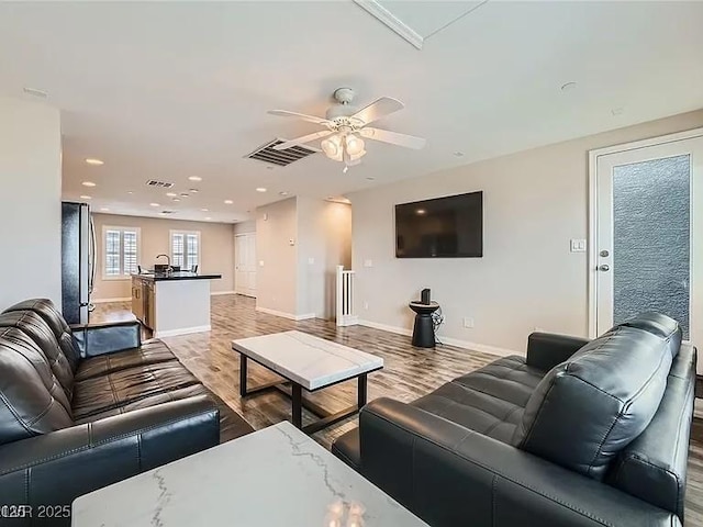 9050 W Tropicana Ave Unit 1015, Las Vegas, NV 89147 - living room with a ceiling fan, light wood finished floors, and recessed lighting