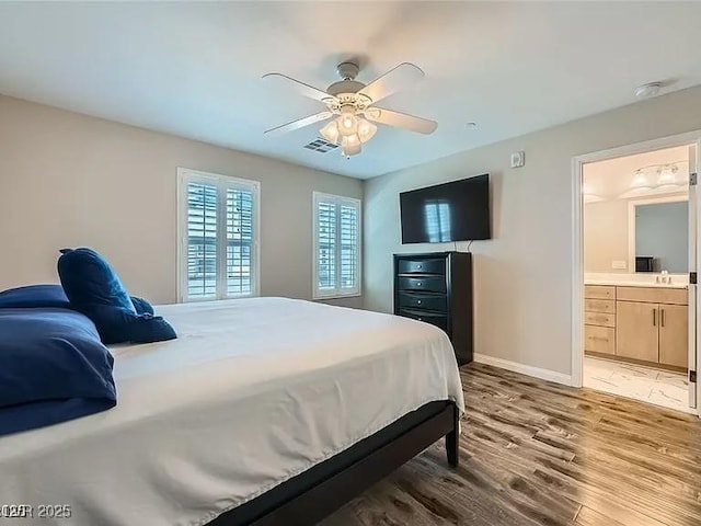 9050 W Tropicana Ave Unit 1015, Las Vegas, NV 89147 - bedroom with light wood-style flooring, ensuite bath, and a ceiling fan