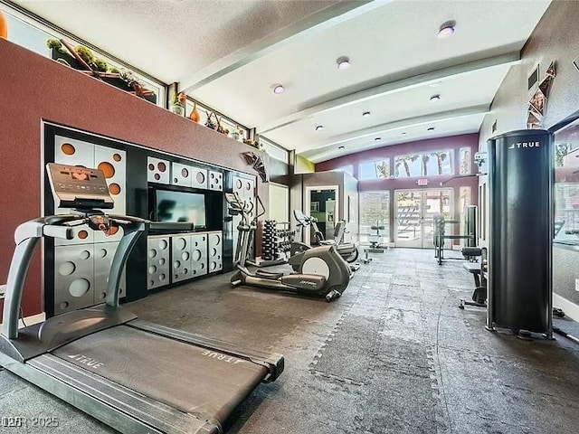 9050 W Tropicana Ave Unit 1015, Las Vegas, NV 89147 - gym with beam ceiling, high vaulted ceiling, and a textured ceiling