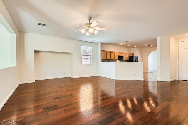 193 Lynbrook St, Henderson, NV 89012 - unfurnished living room with ceiling fan, arched walkways, dark wood-style flooring, and recessed lighting