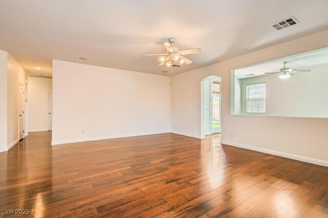 193 Lynbrook St, Henderson, NV 89012 - empty room featuring ceiling fan, wood-type flooring, and arched walkways