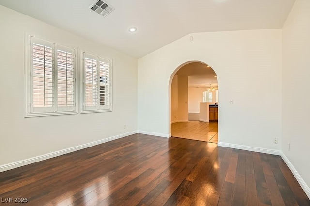 193 Lynbrook St, Henderson, NV 89012 - spare room featuring wood-type flooring, vaulted ceiling, arched walkways, and recessed lighting