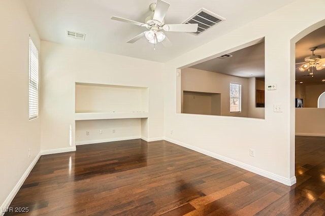 193 Lynbrook St, Henderson, NV 89012 - unfurnished living room featuring ceiling fan, arched walkways, and hardwood / wood-style flooring