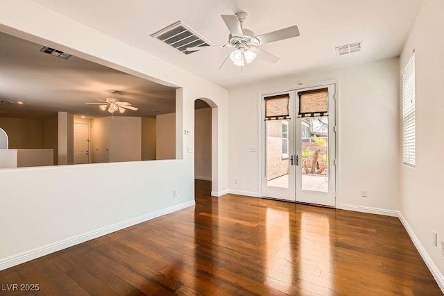 193 Lynbrook St, Henderson, NV 89012 - unfurnished room featuring ceiling fan, french doors, arched walkways, and hardwood / wood-style flooring