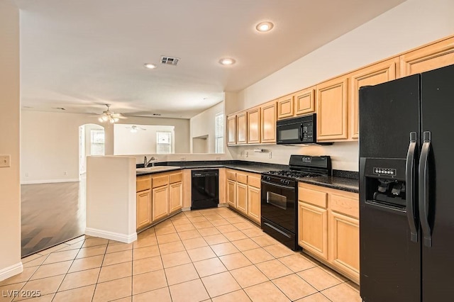 193 Lynbrook St, Henderson, NV 89012 - kitchen with black appliances, light brown cabinets, dark countertops, a ceiling fan, and a peninsula
