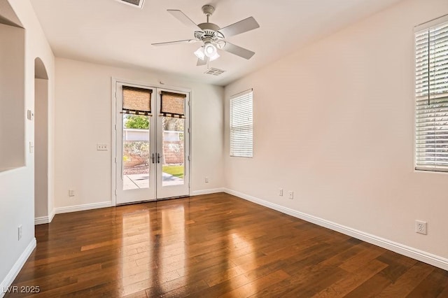 193 Lynbrook St, Henderson, NV 89012 - empty room with french doors, wood-type flooring, ceiling fan, and arched walkways