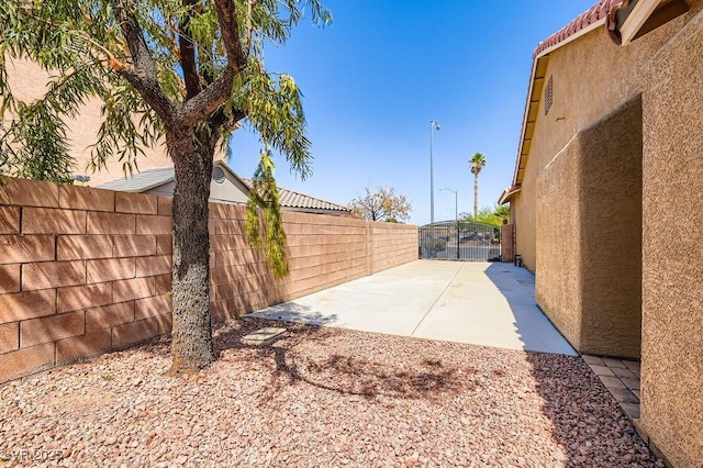 193 Lynbrook St, Henderson, NV 89012 - fenced backyard featuring a patio and a gate