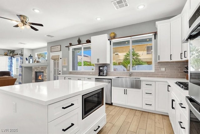 7816 Red Leaf Dr, Las Vegas, NV 89131 - kitchen featuring appliances with stainless steel finishes, recessed lighting, ceiling fan, decorative backsplash, and light countertops