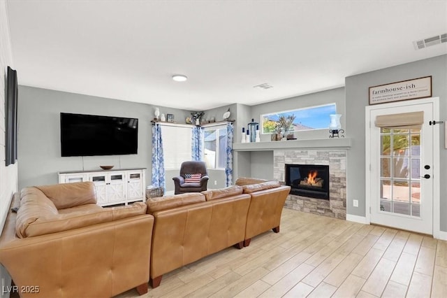 7816 Red Leaf Dr, Las Vegas, NV 89131 - living room with light wood-style flooring and a stone fireplace