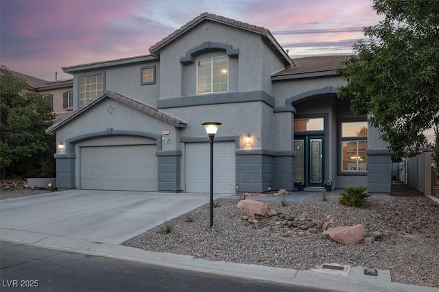 7816 Red Leaf Dr, Las Vegas, NV 89131 - view of front of home featuring concrete driveway, a garage, and stucco siding