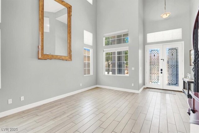 7816 Red Leaf Dr, Las Vegas, NV 89131 - foyer entrance with a high ceiling, french doors, and wood finished floors
