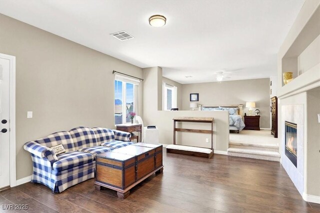 7816 Red Leaf Dr, Las Vegas, NV 89131 - bedroom with dark wood-style flooring and a glass covered fireplace