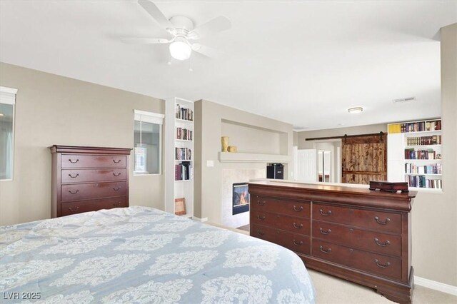 7816 Red Leaf Dr, Las Vegas, NV 89131 - bedroom with a barn door, light colored carpet, and ceiling fan
