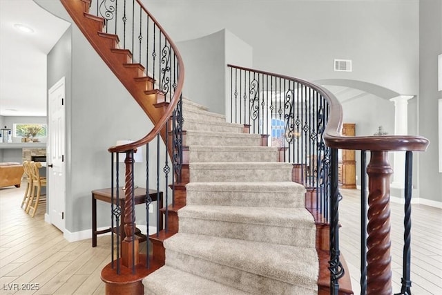 7816 Red Leaf Dr, Las Vegas, NV 89131 - staircase with wood finished floors and arched walkways