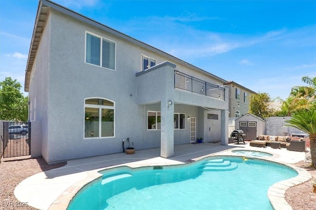 7816 Red Leaf Dr, Las Vegas, NV 89131 - back of property with a balcony, a storage shed, a patio area, stucco siding, and an outdoor living space