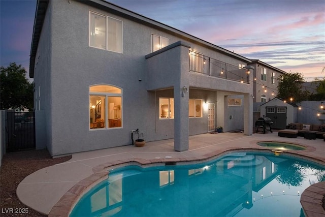 7816 Red Leaf Dr, Las Vegas, NV 89131 - back of house at dusk with a balcony, a patio area, stucco siding, and outdoor lounge area