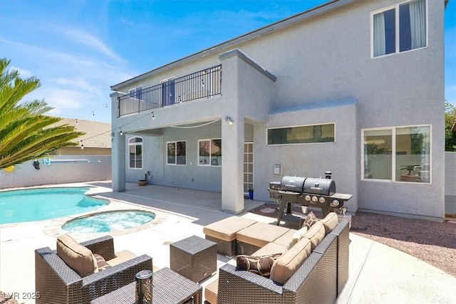 7816 Red Leaf Dr, Las Vegas, NV 89131 - rear view of house with a balcony, a patio, stucco siding, and a pool with connected hot tub