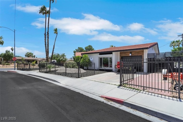 1900 S 15th St, Las Vegas, NV 89104 - ranch-style home with an attached garage, driveway, a fenced front yard, stucco siding, and a gate