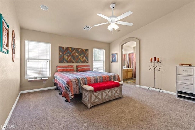 5208 Regena Rose St, North Las Vegas, NV 89081 - bedroom with carpet flooring, arched walkways, connected bathroom, ceiling fan, and vaulted ceiling