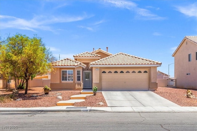 5208 Regena Rose St, North Las Vegas, NV 89081 - mediterranean / spanish house featuring driveway, an attached garage, stucco siding, and a tile roof
