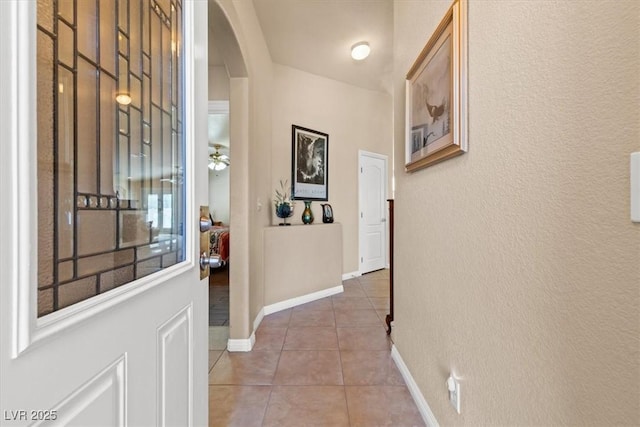 5208 Regena Rose St, North Las Vegas, NV 89081 - hallway featuring arched walkways, light tile patterned floors, and a textured wall