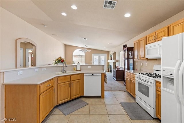 5208 Regena Rose St, North Las Vegas, NV 89081 - kitchen with white appliances, lofted ceiling, arched walkways, ceiling fan, and light countertops