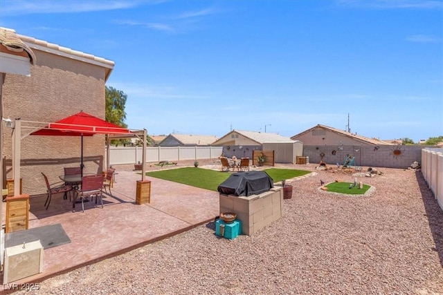 5208 Regena Rose St, North Las Vegas, NV 89081 - fenced backyard with outdoor dining space and a patio area