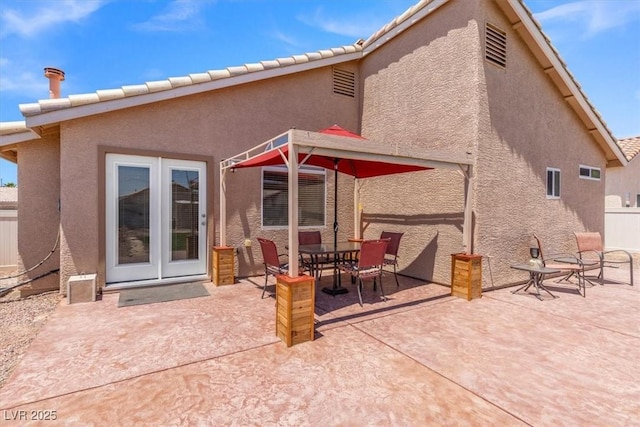 5208 Regena Rose St, North Las Vegas, NV 89081 - rear view of house with a patio, stucco siding, and french doors
