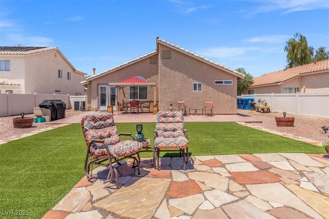 5208 Regena Rose St, North Las Vegas, NV 89081 - rear view of house with a patio area, stucco siding, and a fenced backyard