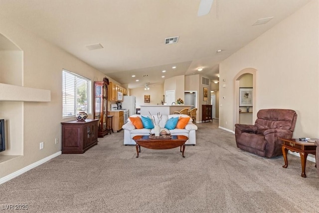 5208 Regena Rose St, North Las Vegas, NV 89081 - living area with light carpet, vaulted ceiling, and arched walkways
