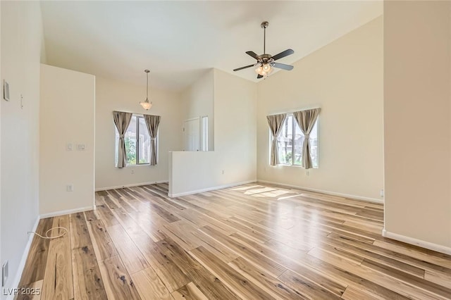 8805 Jeffreys St Unit 1089, Las Vegas, NV 89123 - unfurnished living room featuring light wood finished floors, ceiling fan, and lofted ceiling