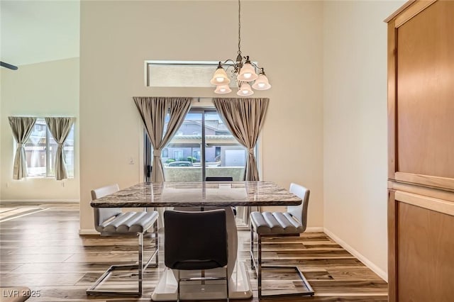 8805 Jeffreys St Unit 1089, Las Vegas, NV 89123 - dining area featuring a chandelier, dark wood-style flooring, and a towering ceiling