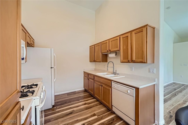 8805 Jeffreys St Unit 1089, Las Vegas, NV 89123 - kitchen featuring white appliances, wood finished floors, a high ceiling, light countertops, and brown cabinets