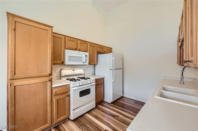 8805 Jeffreys St Unit 1089, Las Vegas, NV 89123 - kitchen with white appliances, light countertops, and wood finished floors