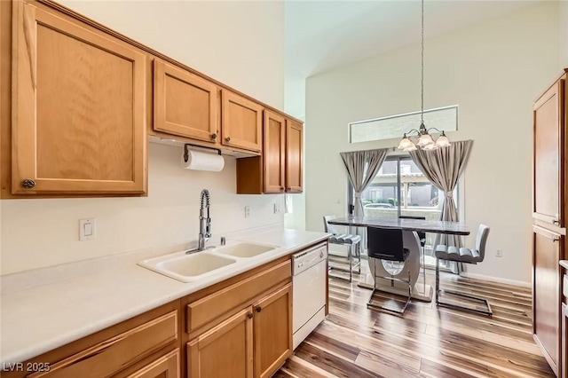 8805 Jeffreys St Unit 1089, Las Vegas, NV 89123 - kitchen with dishwasher, wood finished floors, a chandelier, light countertops, and hanging light fixtures