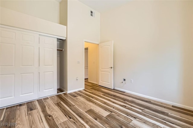 8805 Jeffreys St Unit 1089, Las Vegas, NV 89123 - unfurnished bedroom with a closet, wood finished floors, and a towering ceiling