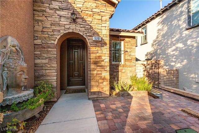 520 Ivy Spring St, Las Vegas, NV 89138 - doorway to property with stone siding and a patio area