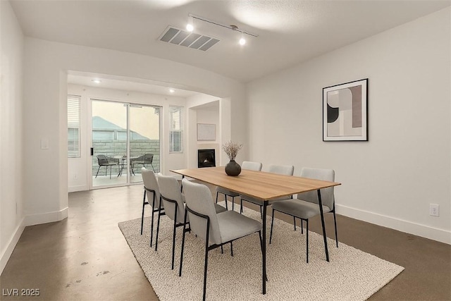 520 Ivy Spring St, Las Vegas, NV 89138 - dining room featuring rail lighting and finished concrete floors