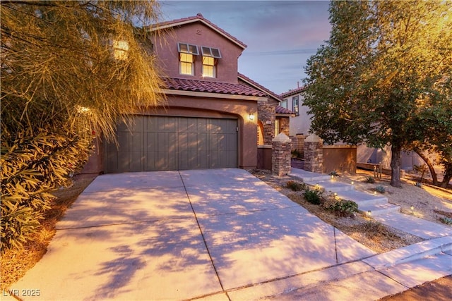 520 Ivy Spring St, Las Vegas, NV 89138 - mediterranean / spanish-style home with a tile roof, stucco siding, concrete driveway, a garage, and stone siding